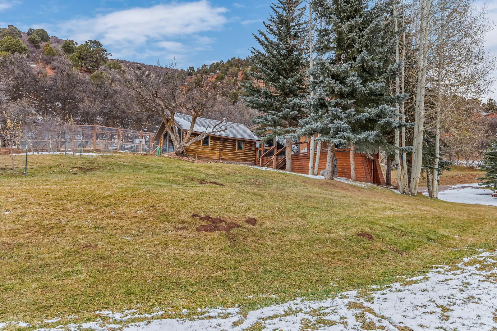 Late-fall lawn below the log house
